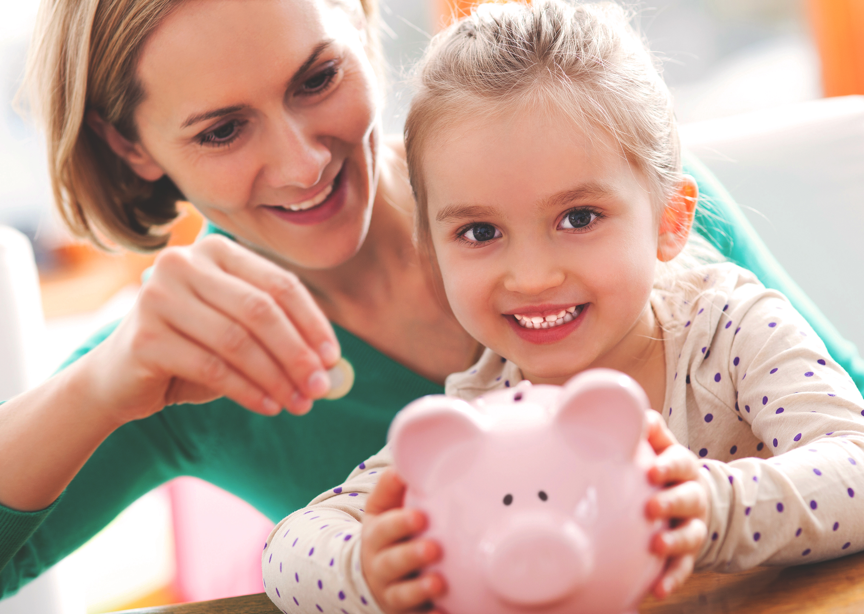 mother and child with piggy bank