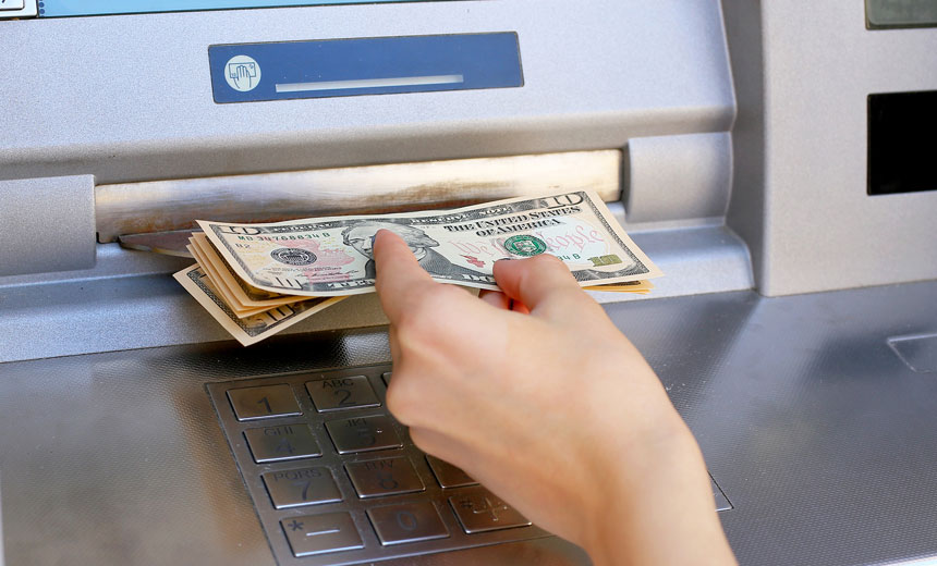 hand reaching for cash at atm