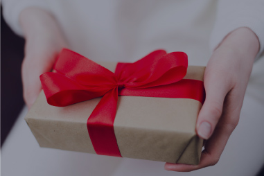 Woman holding a wrapped gift.
